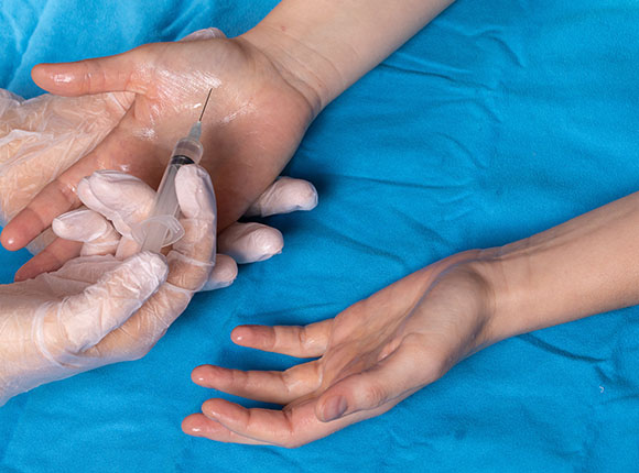 hands before injection with syringe on blue background medical procedure for six health benefits