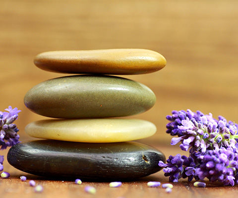 stacked stones with lavender flowers calming spa experience eight relaxation wellness