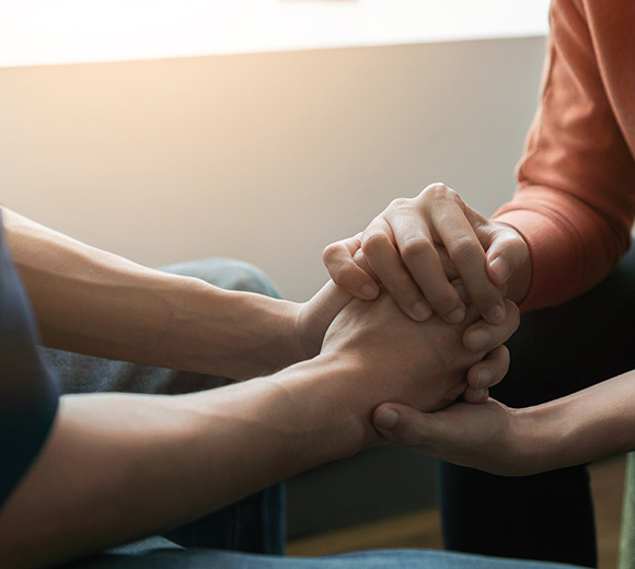 two hands together in support showing connection and trust